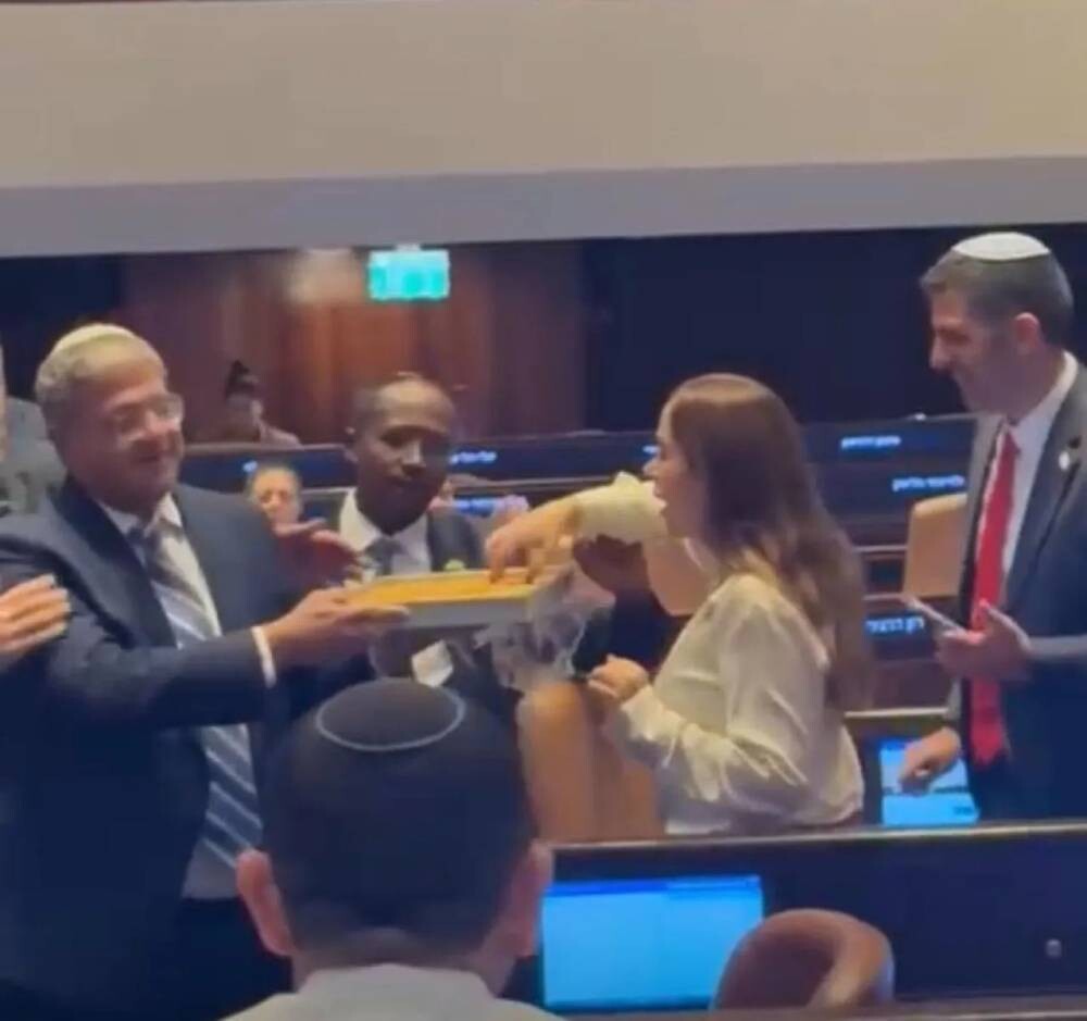 Israeli Minister Distributes Sweets in Parliament